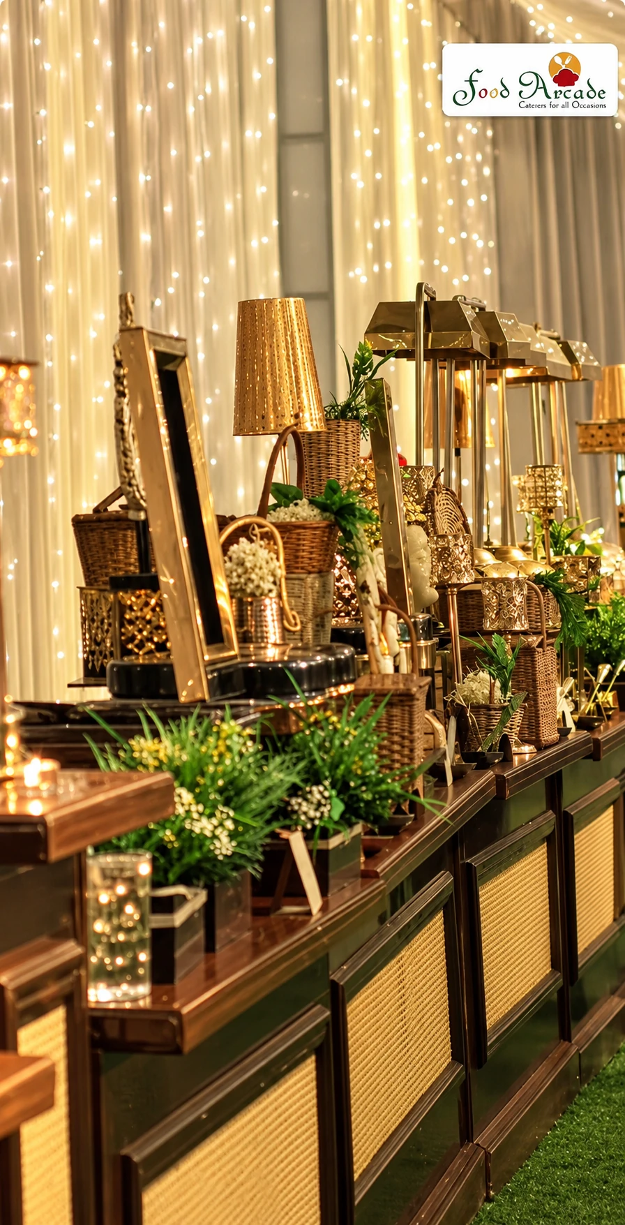 Buffet counter decorated with brass lamps, baskets and greenery against a curtain of fairy lights